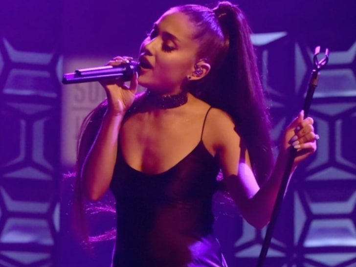 Ariana Grande singing in concert performance