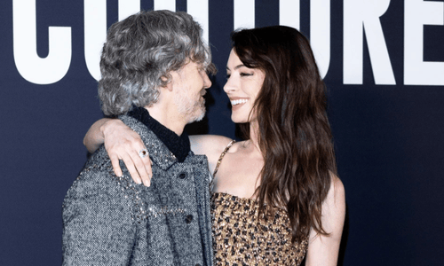 Anne Hathaway and Adam Shulman smiling together at a public event