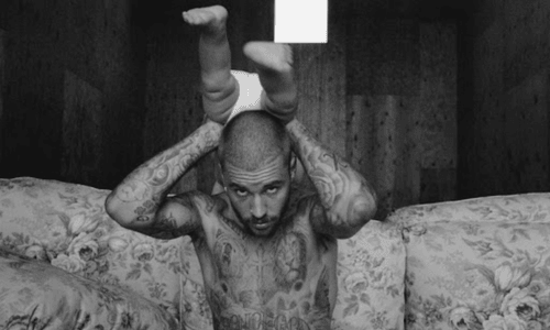 Justin Bieber holding son Jack Blues in a studio-themed promo photo.