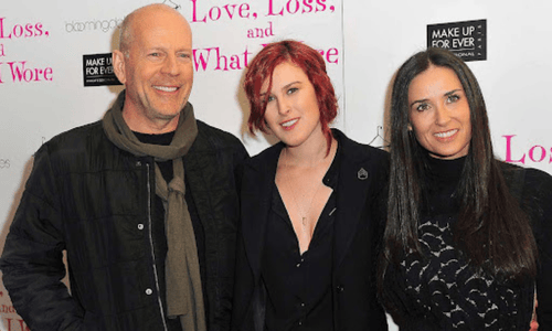 Bruce Willis, his daughter Rumer Willis, and his ex-wife Demi Moore are posing together at an event.