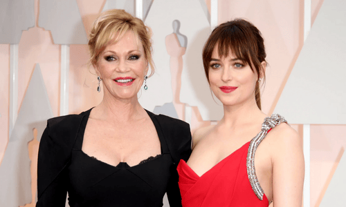 Melanie Griffith and her daughter, Dakota Johnson, posing together on a red carpet. 