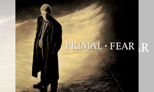 Movie poster for "Primal Fear" featuring a man in a dark overcoat standing under dramatic lighting with large shadowed wings in the background.