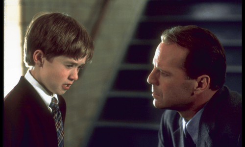 Young boy and man in emotional scene from The Sixth Sense, revealing a shocking twist about the man's true fate.