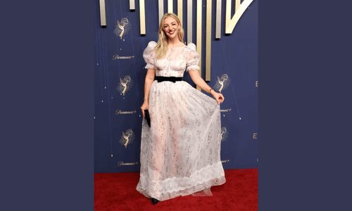Abby Elliott in white gown at Emmys 2025 red carpet fail.