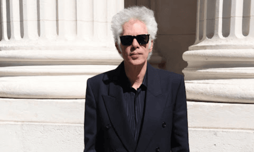 Director Jim Jarmusch in sunglasses, known for Father Mother Sister Brother and acclaimed indie films.