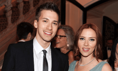 Scarlett Johansson posing with her twin brother Hunter Johansson at an event.