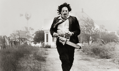 Leatherface from Texas Chainsaw Massacre wielding chainsaw in horror scene.