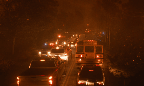 Terrifying wildfire scene from The Lost Bus showing smoke, flames, and chaos.