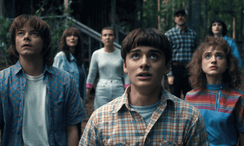 A tense moment from Stranger Things with main characters looking shocked, symbolizing the raised stakes and chaos in Season 5.