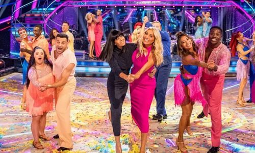 Celebrity contestants and professional dancers performing together on the Strictly Come Dancing Christmas Special stage.