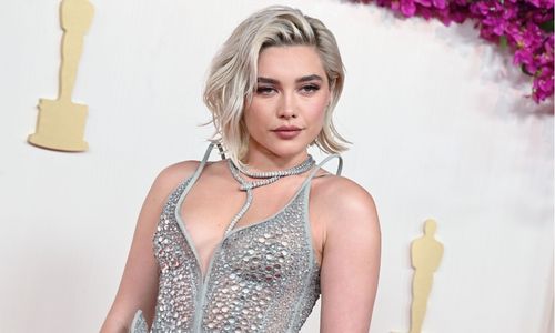 Florence Pugh Sheer high fashion outfit styled with strong tailoring on the red carpet.