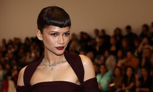 High-fashion red carpet look featuring a sculptural couture gown with dramatic silhouette