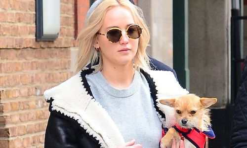 Jennifer Lawrence spending time with her dog during a casual outing.