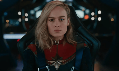 Brie Larson as Captain Marvel seated in a cockpit, focused before action.