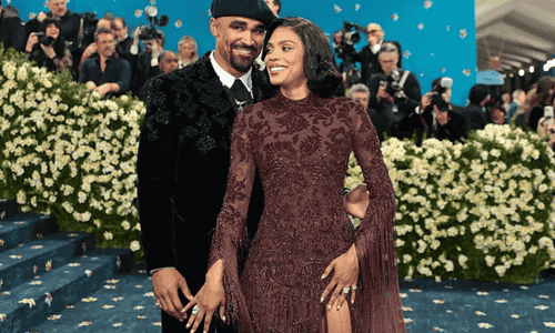 Jalen Hurts and Bry Burrows posing together at their wedding.