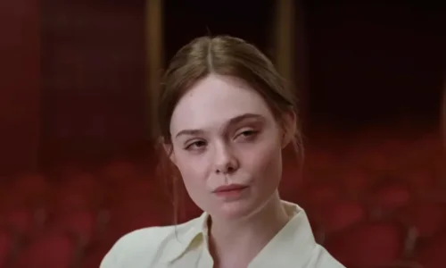 A close-up portrait of Elle Fanning with a serious expression in the film 'Sentimental Value.'