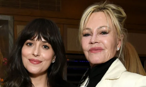A vintage-style photo of a young Dakota Johnson, showcasing her early life as the daughter of Melanie Griffith and Don Johnson.