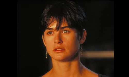 A classic headshot of Demi Moore with short hair, providing context on her past relationships and journey through loss.