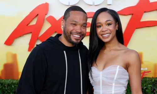 Eric Murphy and Jasmin Lawrence posing together on a red carpet, smiling for cameras.