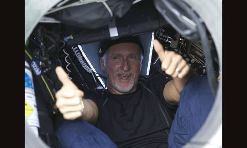James Cameron giving two thumbs up through the porthole of the DEEPSEA CHALLENGER submersible after his record-breaking solo dive.