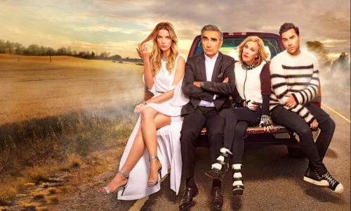 This image shows the cast of the television sitcom Schitt's Creek, featuring the Rose family sitting on the back of a truck. 