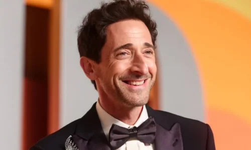 Adrien Brody as architect Laszlo Toth in a dramatic close-up scene from the film The Brutalist.