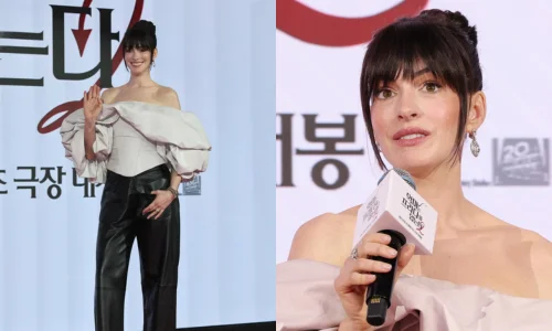 Anne Hathaway speaking at a press conference for the 2026 film "The Devil Wears Prada 2".
