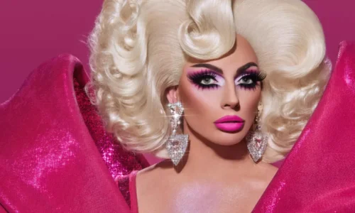 Drag legend Alyssa Edwards, winner of Global All Stars, in a high-fashion hot pink look with voluminous blonde hair and bold makeup.