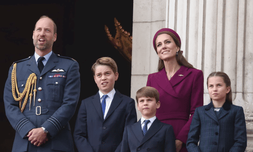 This image captures a moment of the British Royal family on a balcony, likely Buckingham Palace, during a public appearance