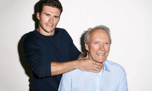 A playful portrait of Scott Eastwood smiling while jokingly holding his father Clint Eastwood by the neck.