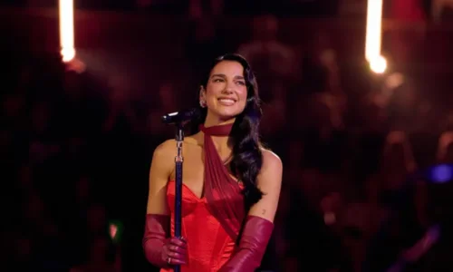 This image features singer-songwriter Dua Lipa performing at the Royal Albert Hall in London.