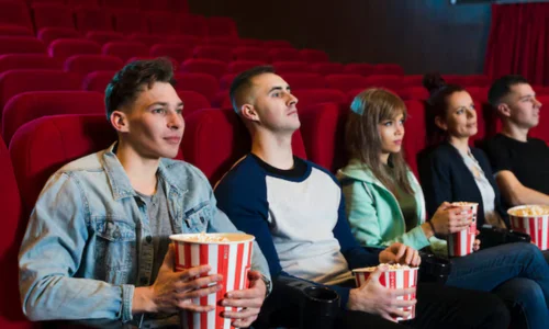 A diverse group of people sitting in a movie theater.
