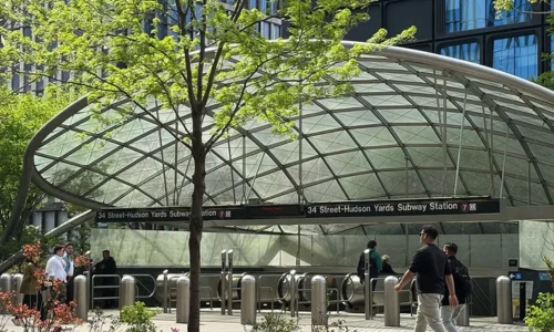 The modern entrance to the Hudson Yards subway station where Andy Sachs is filmed in the 2026 sequel.