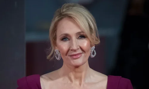 Author J.K. Rowling smiling at a book release event.