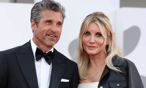 Patrick Dempsey and wife Jillian Fink smiling together at an outdoor event.