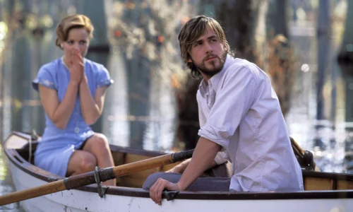 Ryan Gosling and Rachel McAdams embracing passionately in the rain in a scene from The Notebook.