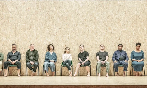Emilia Clarke seated with the cast of The Seagull on stage