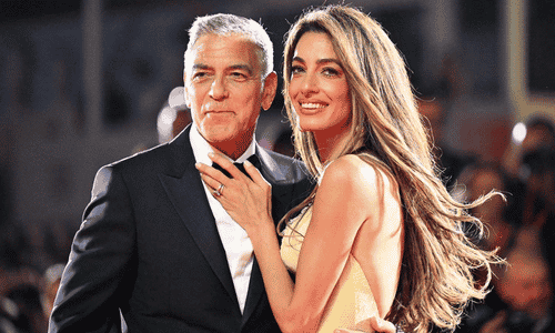 George Clooney and his wife, human rights barrister Amal Clooney, smiling together at a high-profile gala.