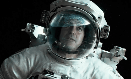 George Clooney as astronaut Matt Kowalski floating in a spacesuit during the film Gravity.