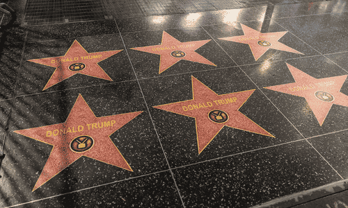 A street-level view of multiple Donald Trump stars on the Hollywood Walk of Fame. 