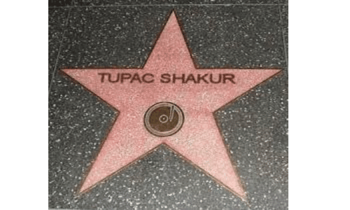 A close-up view of Tupac Shakur's posthumous star on the Hollywood Walk of Fame.