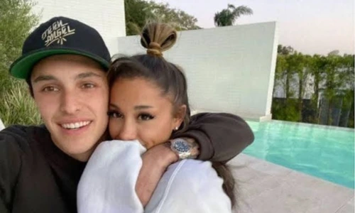 A close-up selfie of Ariana Grande and Dalton Gomez smiling directly at the camera.