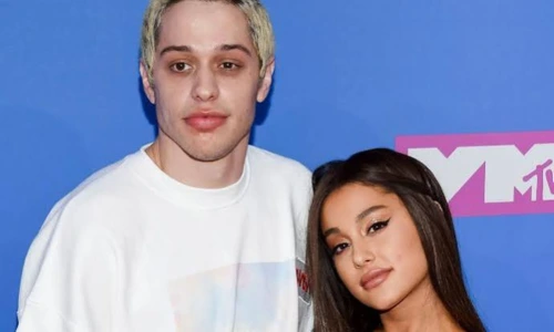 Ariana Grande and Pete Davidson posing together on the pink carpet at the MTV Video Music Awards.