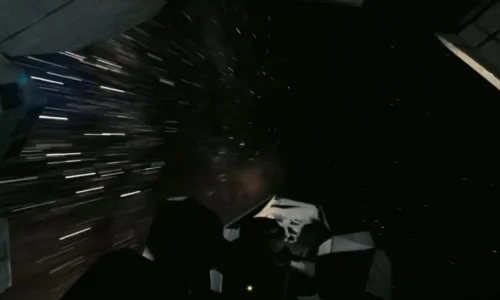 A modular spaceship enters a swirling wormhole with light streaks stretching across deep space in Interstellar.