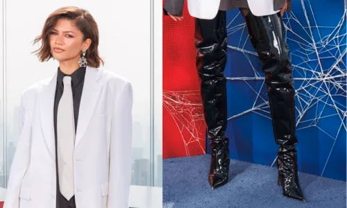 Zendaya posing in a pantsless blazer look with thigh-high black boots at a Spider-Man event