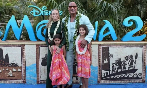 Dwayne Johnson poses with wife Lauren Hashian and their daughters in tropical outfits at the Moana 2 premiere event.