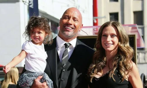 Dwayne Johnson and Lauren Hashian attending an event with their children