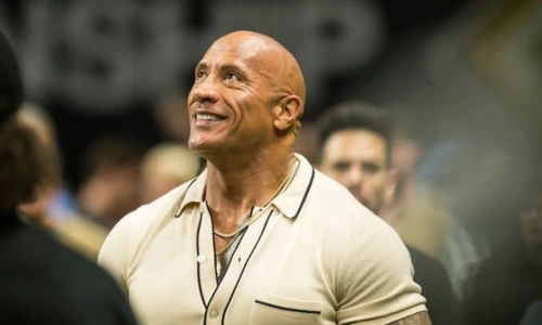 Dwayne Johnson smiling at a public event after supporting entertainment workers