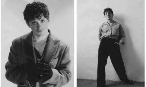 Black-and-white portraits of Ethan Slater posing in a coat and loose trousers