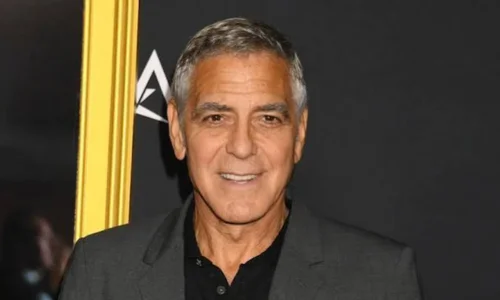 George Clooney wearing a black suit at a public event